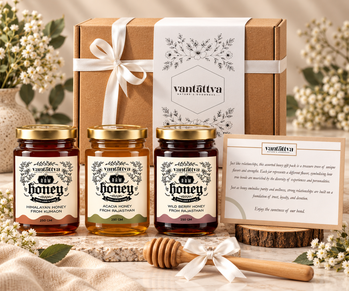 Three 250g jars of raw honey (Himalayan Forest, Sheesham, Wild Flora) with a wooden dipper in a craft gift box. Ideal for festive and corporate gifting.